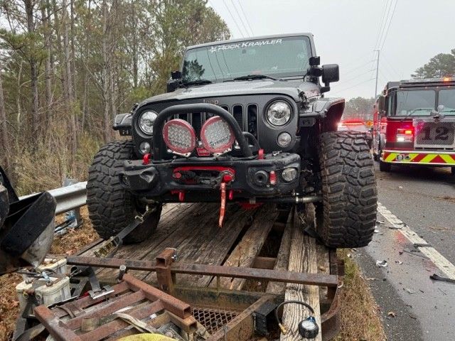 Close-up of Jeep secured to crashed truck with one Mac's strap
