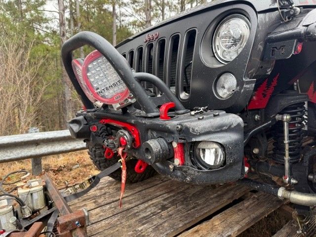 Jeep secured to crashed truck with one Mac's strap